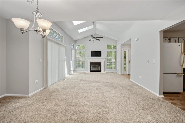 30W014 Willow Ln Unit 1, Warrenville, IL 60555 - unfurnished living room with lofted ceiling, a tile fireplace, a skylight, carpet flooring, and ceiling fan
