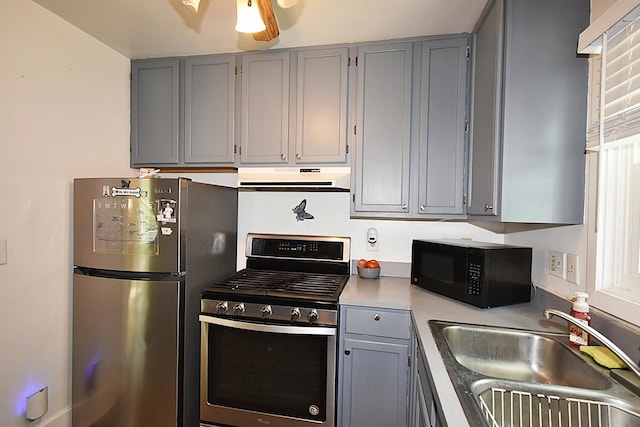 717 Carlisle Rd, Batavia, IL 60510 - kitchen featuring appliances with stainless steel finishes, gray cabinetry, under cabinet range hood, and light countertops