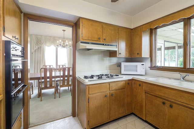 1131 Blanchard St, Downers Grove, IL 60516 - kitchen featuring under cabinet range hood, white appliances, plenty of natural light, and a chandelier