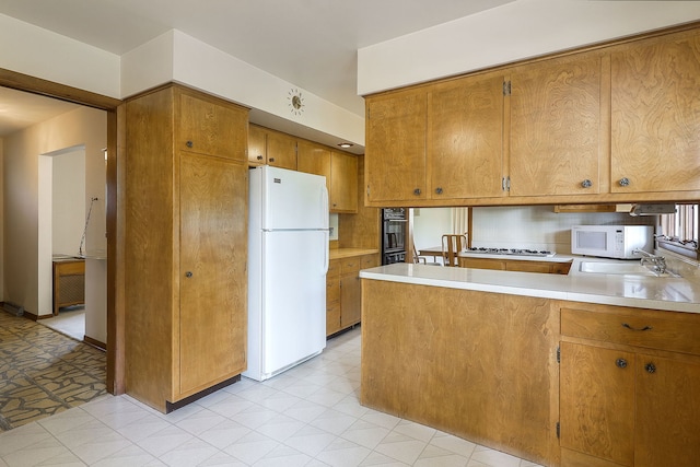 1131 Blanchard St, Downers Grove, IL 60516 - kitchen featuring white appliances, light flooring, brown cabinets, light countertops, and a peninsula