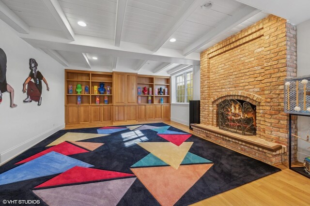 677 Greenleaf Ave, Glencoe, IL 60022 - workout room featuring a brick fireplace, wood finished floors, baseboards, and recessed lighting