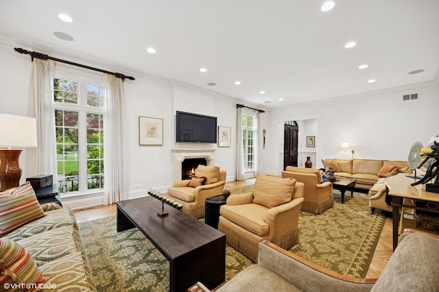 677 Greenleaf Ave, Glencoe, IL 60022 - living area featuring ornamental molding, recessed lighting, a warm lit fireplace, and baseboards