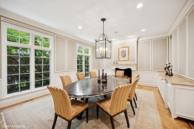 677 Greenleaf Ave, Glencoe, IL 60022 - dining room featuring a decorative wall, a chandelier, crown molding, a warm lit fireplace, and recessed lighting