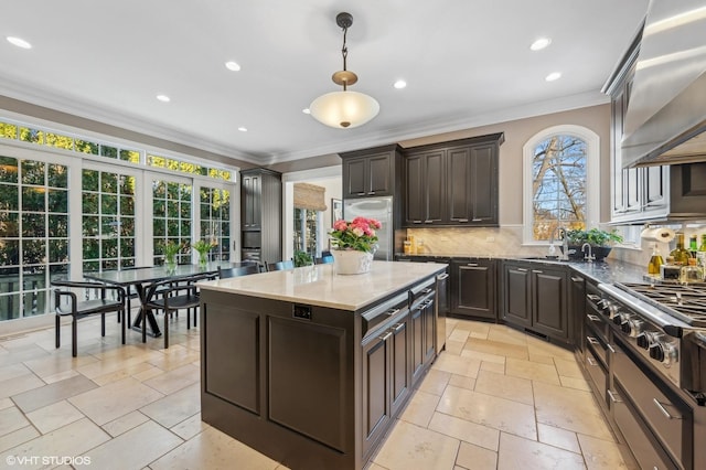 677 Greenleaf Ave, Glencoe, IL 60022 - kitchen with stainless steel appliances, wall chimney range hood, ornamental molding, decorative backsplash, and dark brown cabinetry