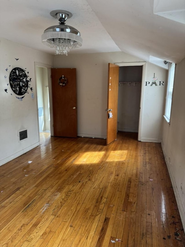 10035 S Yates Blvd, Chicago, IL 60617 - spare room featuring wood-type flooring and baseboards