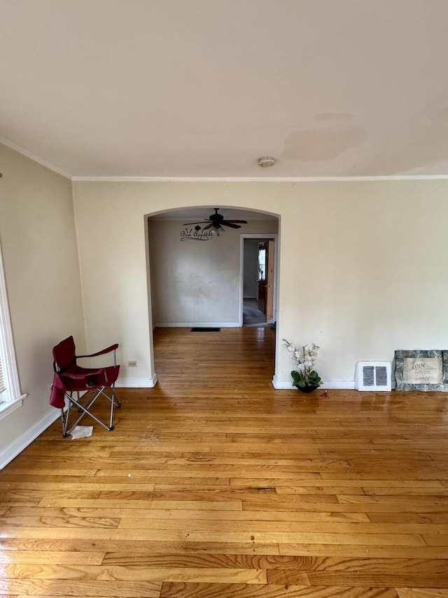 10035 S Yates Blvd, Chicago, IL 60617 - empty room with arched walkways, crown molding, baseboards, light wood-style flooring, and a smoke detector