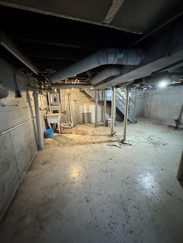 10035 S Yates Blvd, Chicago, IL 60617 - unfinished below grade area with stairs, electric panel, and a sink