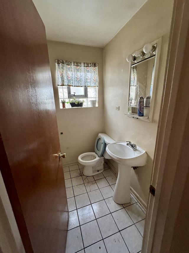 10035 S Yates Blvd, Chicago, IL 60617 - half bath featuring tile patterned flooring, toilet, and baseboards