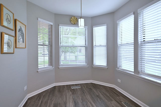 2136 Camden Ln Unit 2136, Hanover Park, IL 60133 - unfurnished dining area featuring dark wood-type flooring, plenty of natural light, and baseboards