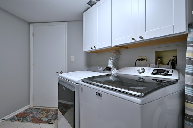 2136 Camden Ln Unit 2136, Hanover Park, IL 60133 - laundry room with washer and dryer, cabinet space, baseboards, and tile patterned floors