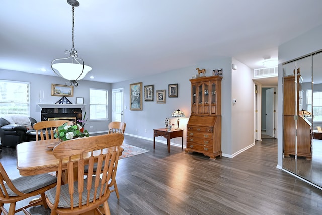 2136 Camden Ln Unit 2136, Hanover Park, IL 60133 - dining space featuring dark wood-style floors, plenty of natural light, baseboards, a high end fireplace, and recessed lighting
