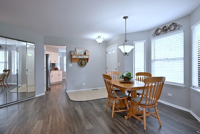 2136 Camden Ln Unit 2136, Hanover Park, IL 60133 - dining space featuring dark wood-style floors, baseboards, and healthy amount of natural light