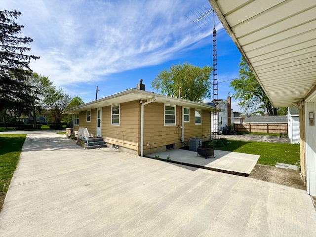 1128 Somonauk St, Sycamore, IL 60178 - rear view of house featuring a patio area, cooling unit, and a chimney