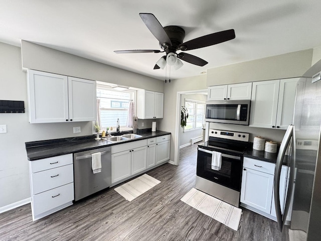 1128 Somonauk St, Sycamore, IL 60178 - kitchen with appliances with stainless steel finishes, a sink, baseboards, and dark countertops