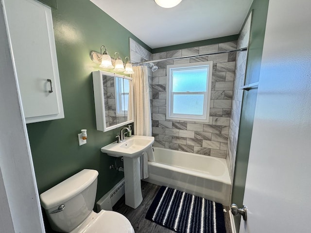1128 Somonauk St, Sycamore, IL 60178 - bathroom featuring toilet, shower / tub combo with curtain, and a baseboard radiator