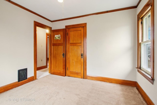 443 Harrison St, West Chicago, IL 60185 - empty room with light carpet, healthy amount of natural light, baseboards, and ornamental molding