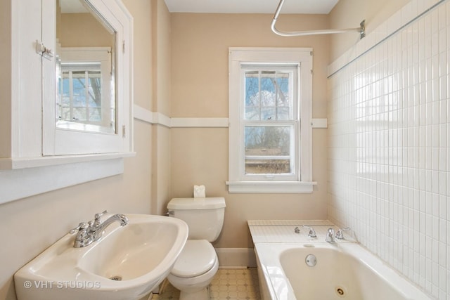 443 Harrison St, West Chicago, IL 60185 - bathroom with toilet, a jetted tub, baseboards, and a sink