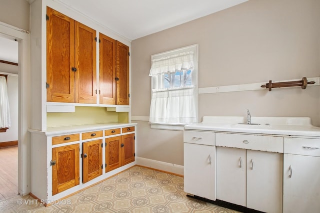 443 Harrison St, West Chicago, IL 60185 - kitchen with baseboards, light countertops, and brown cabinetry
