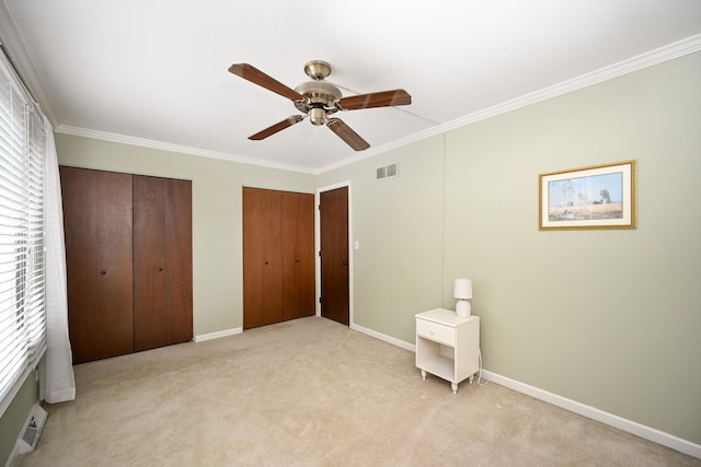 2107 Timber Ln, Wheaton, IL 60189 - unfurnished bedroom featuring two closets, crown molding, light carpet, and ceiling fan