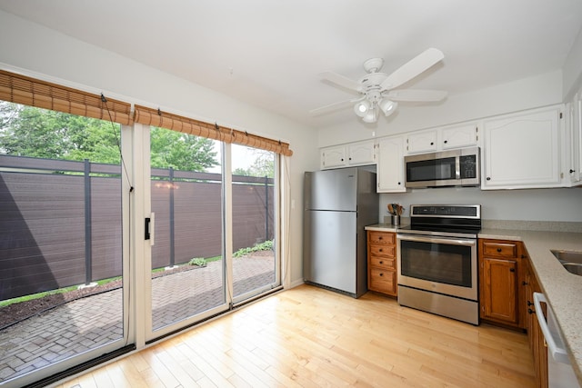 2107 Timber Ln, Wheaton, IL 60189 - kitchen with appliances with stainless steel finishes, white cabinets, light wood-type flooring, and light countertops