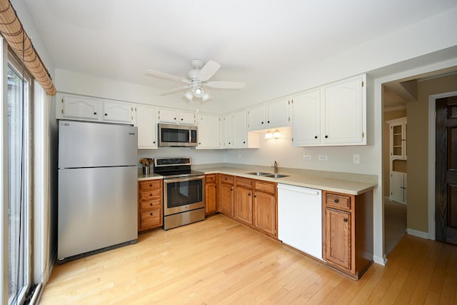 2107 Timber Ln, Wheaton, IL 60189 - kitchen featuring appliances with stainless steel finishes, light countertops, light wood-style flooring, ceiling fan, and white cabinetry