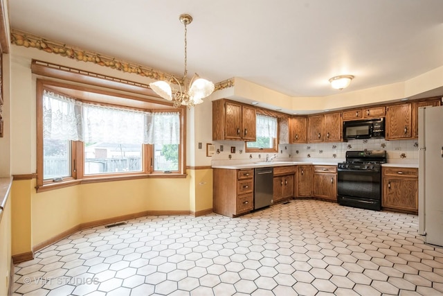 1214 W Talcott Rd, Park Ridge, IL 60068 - kitchen with black appliances, brown cabinetry, light countertops, and a sink