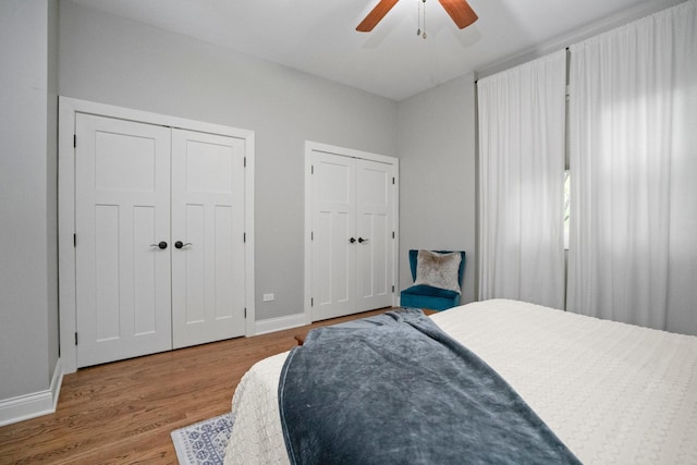 2803 N Wolcott Ave Unit D, Chicago, IL 60657 - bedroom featuring two closets, wood finished floors, baseboards, and ceiling fan