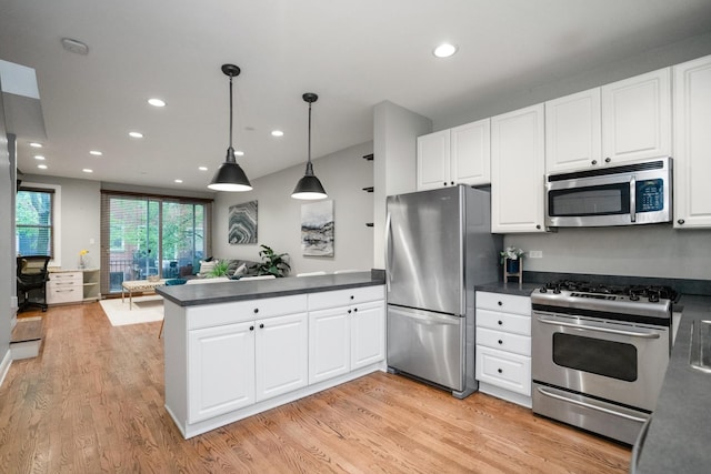2803 N Wolcott Ave Unit D, Chicago, IL 60657 - kitchen featuring stainless steel appliances, a peninsula, dark countertops, open floor plan, and recessed lighting