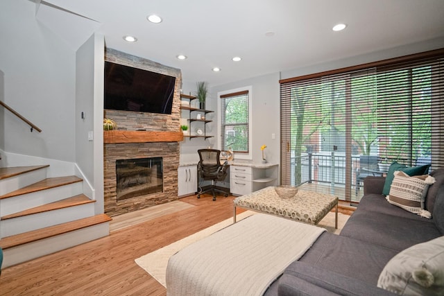 2803 N Wolcott Ave Unit D, Chicago, IL 60657 - living room with light wood-style floors, recessed lighting, stairs, a stone fireplace, and an office area