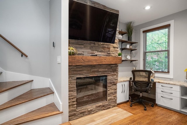 2803 N Wolcott Ave Unit D, Chicago, IL 60657 - home office with light wood-type flooring, built in desk, a stone fireplace, and recessed lighting