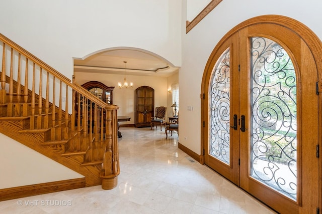 10944 Arbor Ridge Dr, Orland Park, IL 60467 - foyer featuring arched walkways, french doors, a chandelier, and stairs
