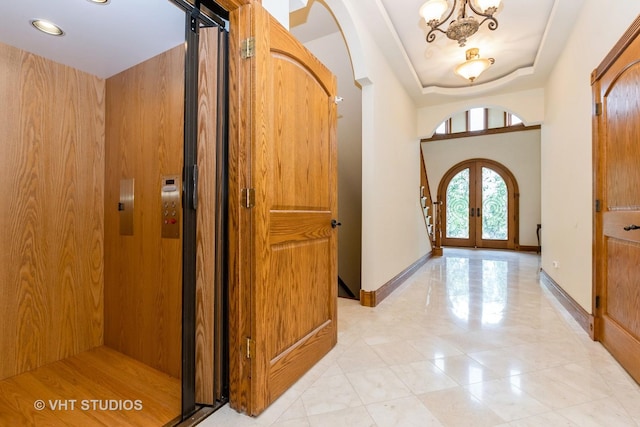10944 Arbor Ridge Dr, Orland Park, IL 60467 - entrance foyer with a chandelier, elevator, french doors, arched walkways, and a tray ceiling