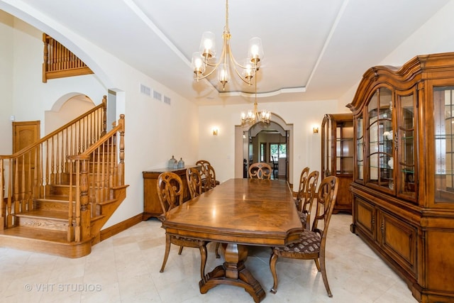 10944 Arbor Ridge Dr, Orland Park, IL 60467 - dining space with a chandelier, arched walkways, a raised ceiling, and stairs