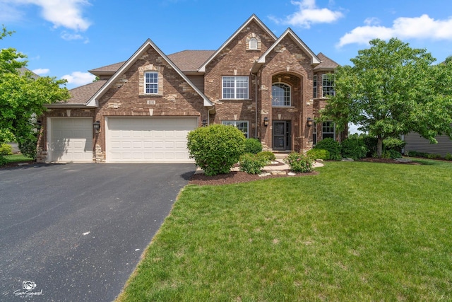 491 Bloomfield Cir W, Oswego, IL 60543 - traditional-style house with brick siding, driveway, a front yard, and a shingled roof