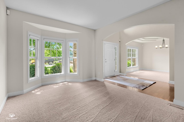 491 Bloomfield Cir W, Oswego, IL 60543 - carpeted foyer with arched walkways, baseboards, and a chandelier