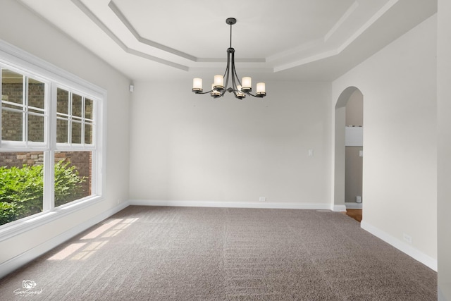 491 Bloomfield Cir W, Oswego, IL 60543 - empty room featuring a tray ceiling, plenty of natural light, a chandelier, and carpet flooring