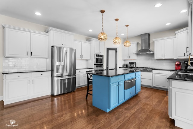491 Bloomfield Cir W, Oswego, IL 60543 - kitchen with stainless steel appliances, wall chimney range hood, a warming drawer, dark countertops, and recessed lighting