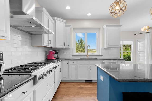 491 Bloomfield Cir W, Oswego, IL 60543 - kitchen featuring wall chimney range hood, a sink, white cabinetry, stainless steel appliances, and recessed lighting