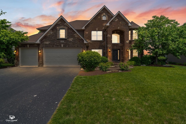 491 Bloomfield Cir W, Oswego, IL 60543 - traditional-style home with asphalt driveway, a front lawn, brick siding, and an attached garage