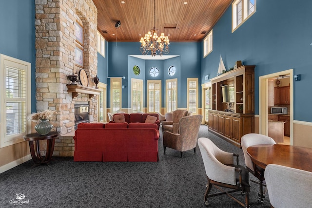 491 Bloomfield Cir W, Oswego, IL 60543 - living area with wooden ceiling, a high ceiling, a chandelier, carpet, and a fireplace