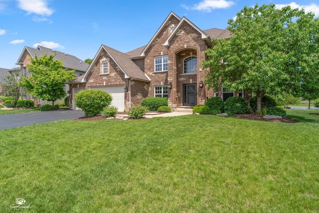 491 Bloomfield Cir W, Oswego, IL 60543 - traditional-style house with brick siding, driveway, a front yard, and a shingled roof