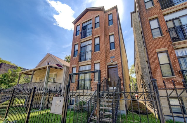 947 W 51st St, Chicago, IL 60609 - view of front of house with a fenced front yard and brick siding