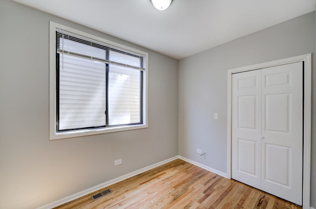 947 W 51st St, Chicago, IL 60609 - unfurnished bedroom with baseboards, light wood finished floors, and a closet