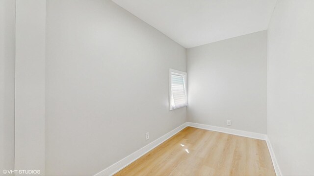 7545 S Perry Ave, Chicago, IL 60620 - unfurnished room featuring light wood-style floors, baseboards, and vaulted ceiling