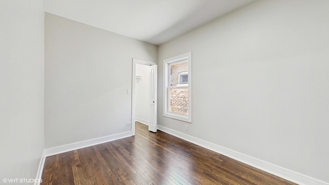 7545 S Perry Ave, Chicago, IL 60620 - unfurnished room featuring baseboards and dark wood-style floors