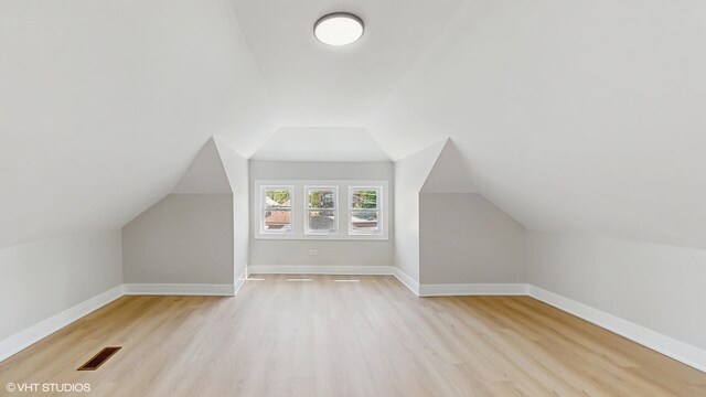7545 S Perry Ave, Chicago, IL 60620 - bonus room with light wood-style floors, vaulted ceiling, and baseboards