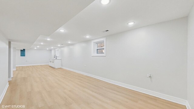 7545 S Perry Ave, Chicago, IL 60620 - finished below grade area featuring baseboards, recessed lighting, light wood-type flooring, electric panel, and a sink