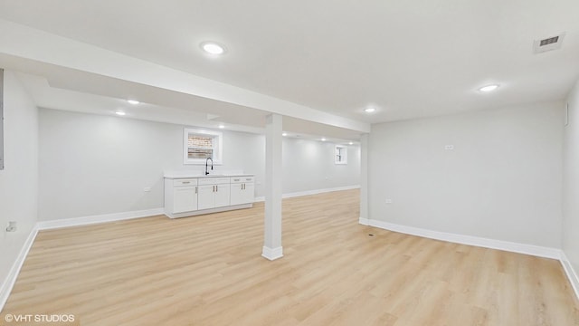 7545 S Perry Ave, Chicago, IL 60620 - finished basement with light wood-type flooring, baseboards, recessed lighting, and a sink