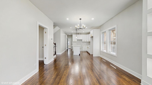 7545 S Perry Ave, Chicago, IL 60620 - unfurnished living room featuring a chandelier, dark wood finished floors, recessed lighting, and baseboards
