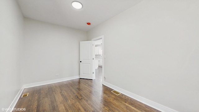 7545 S Perry Ave, Chicago, IL 60620 - empty room with baseboards and dark wood-type flooring